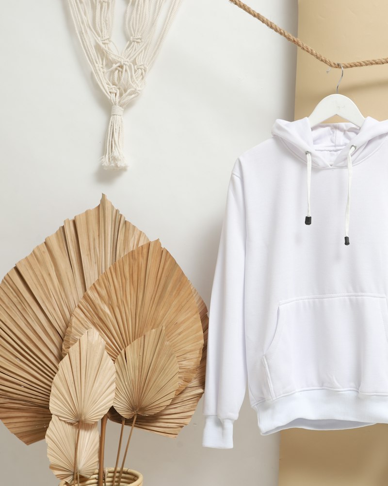 A hoodie hanging beside light jeans