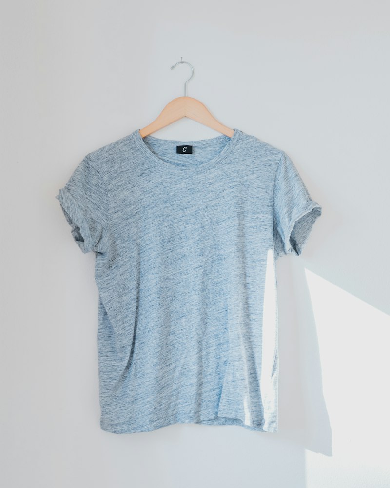A collared polo shirt hanging on a wall